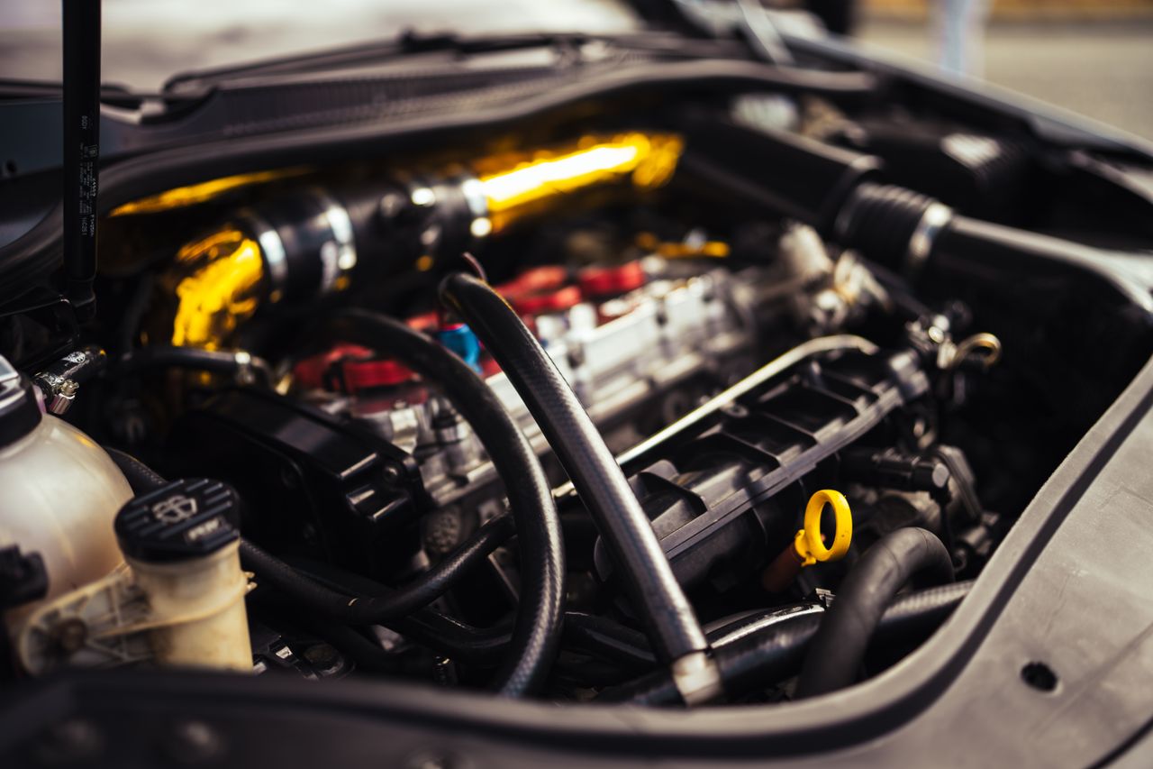The Art of Drawing Readers In: Your attractive post title goes here Detailed image of car engine components showcasing automotive engineering and mechanics.