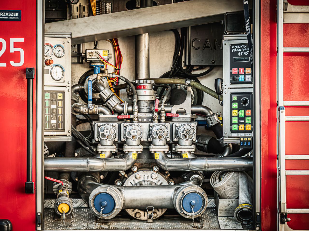 why-choose-us-02 Detailed view of fire truck equipment showcasing gauges, valves, and hoses in Wrocław, Poland.